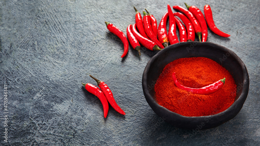 Red chili or chilli cayenne pepper on dark background. - obrazy, fototapety, plakaty 