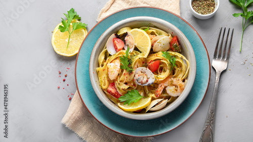 Pasta with seafood on gray background.