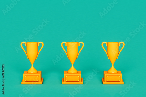 three Yellow trophy on green background photo