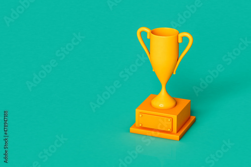 Yellow trophy on green background with copy space