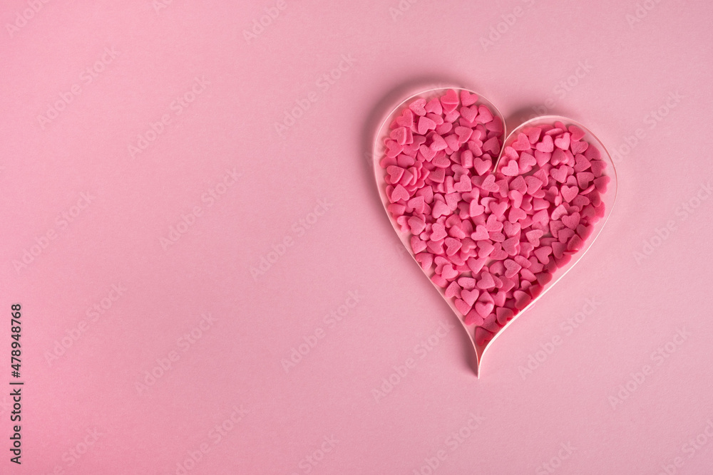 Valentines day composition. Sweet confetti shape of heart on pastel pink background. Top view, flat lay, copy space