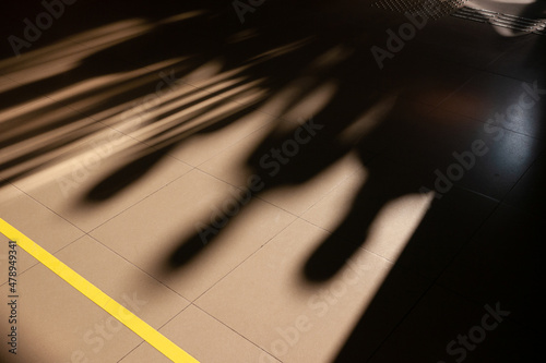 Shadows of people on tiled floor photo