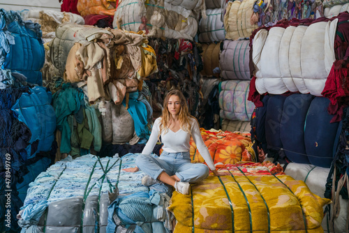Young Woman in a Fabrics Recycling Warehouse photo