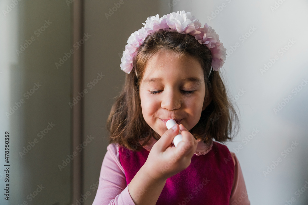 Pretty Little Girl Applying a Lip Balm Pretty Little Girl Applying a Lip Balm