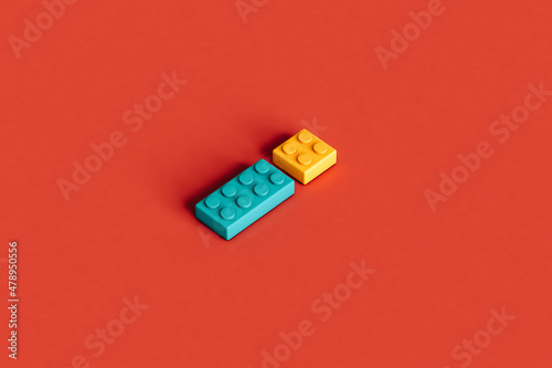 Colorful building blocks isolated on a red background photo