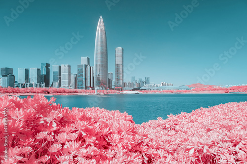 Infrared photography of plants with cityscape by sea