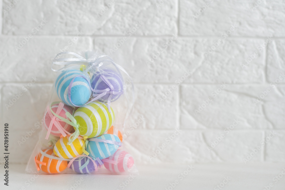 multi-colored chicken eggs in bag mesh on white background. easter multi-colored chicken eggs in bag mesh on white background. easter