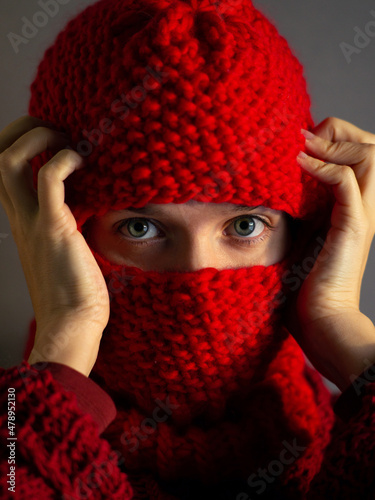 Portrait of a girl in a red knitted balaclava