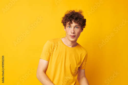 cute red-haired guy Youth style studio casual wear yellow background unaltered