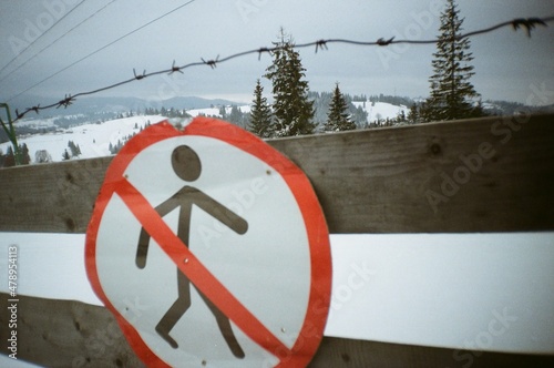 No pedestrian sign on wooden fence photo