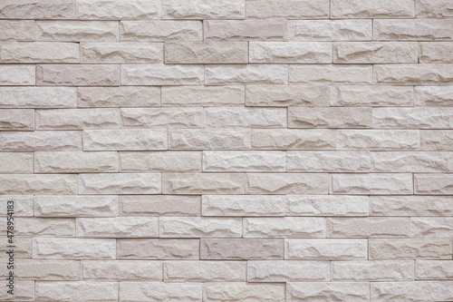 Cream and beige brick wall texture background. Brickwork and stonework flooring interior rock old pattern design. Background of old vintage brick wall backdrop