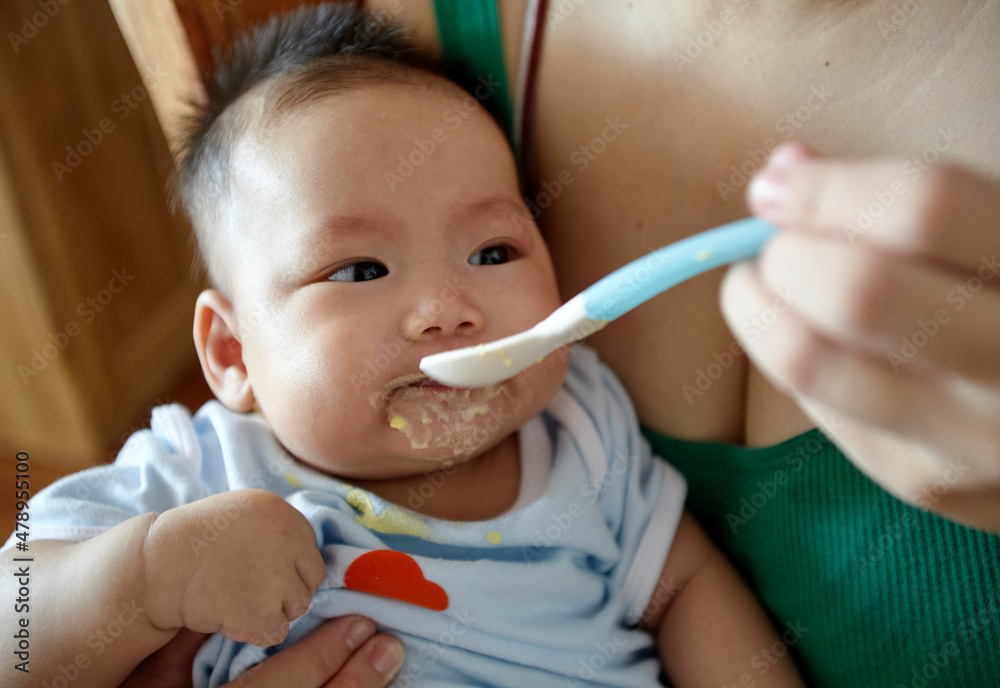 Closeup of Asian baby eating complementary food
Closeup of Asian baby eating complementary food