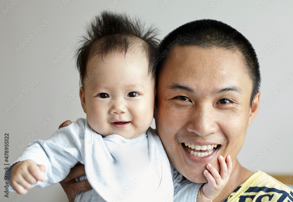 Interaction between Asian baby and dad Interaction between Asian baby and dad