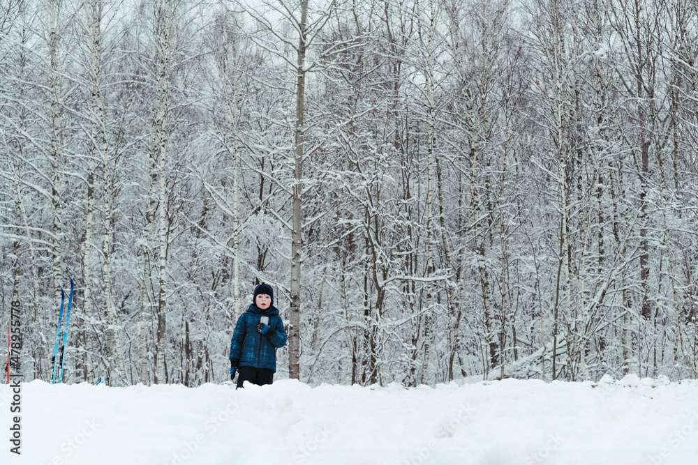 Child walks outside in winter. Child walks outside in winter.