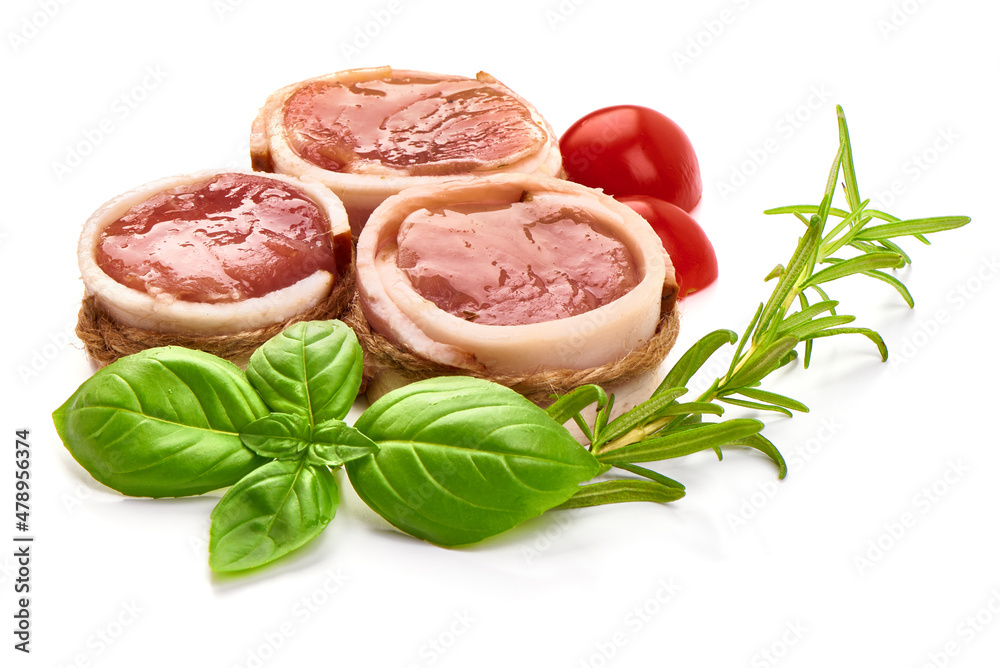 Raw pork tenderloin medallions wrapped in bacon, isolated on white background.