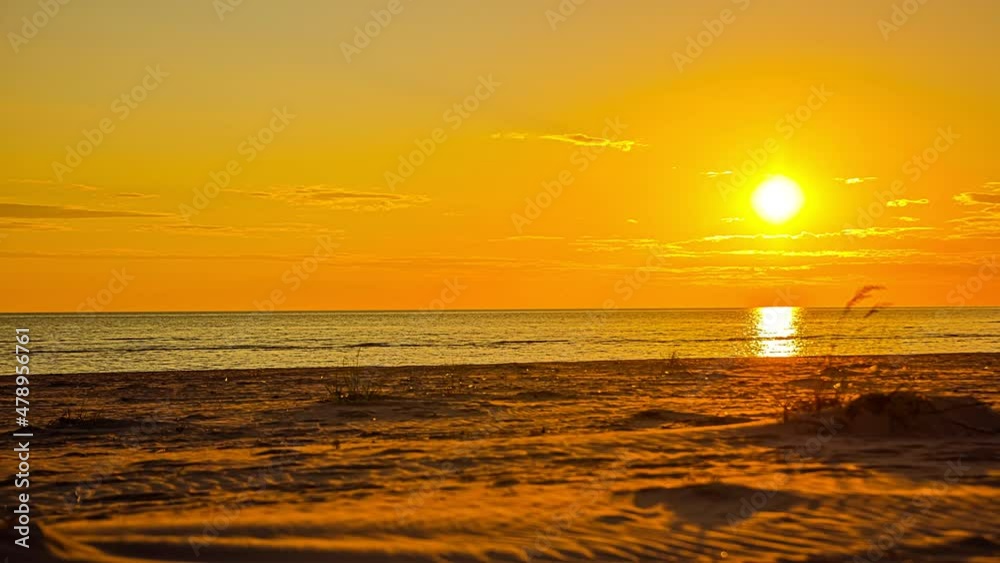 Time - lapse. Sunset on the lake, the sun sets into the lake with attractive yellow sun light and moving clouds. 4K Time - lapse. Sunset on the lake, the sun sets into the lake with attractive yellow sun light and moving clouds. 4K