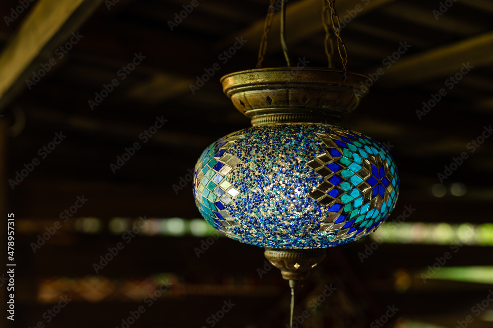 Obraz premium Lamps hanging from the ceiling, mosaic round lamp in wooden interior.