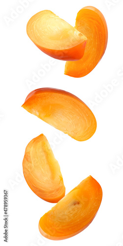 falling pieces of persimmon isolated on a white