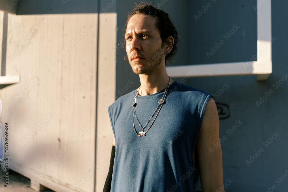 Pensive man standing against wall Pensive man standing against wall