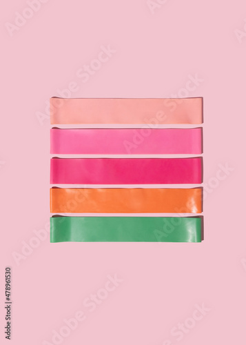 Various fitness elastic bands on pink