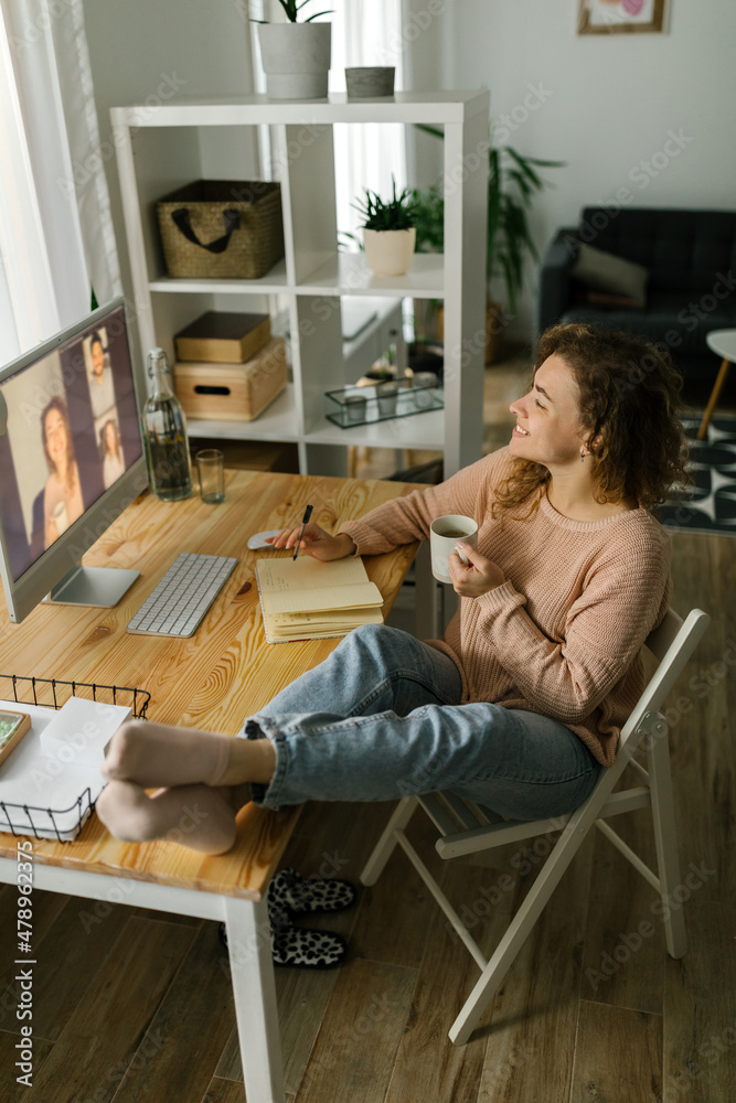 Smiling female video chatting via computer at home Smiling female video chatting via computer at home
