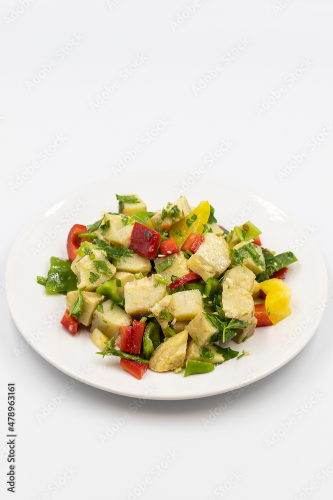 Artichoke salad with olive oil on white background. Traditional delicious Turkish food; (zeytinyagli enginar). Vertical view. Close up