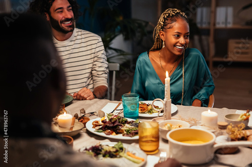 Diverse friends sitting at dinner table