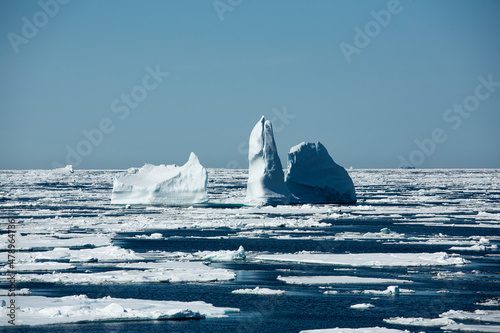 Icebergs floating in the melting sea ice in the Davis Strait. photo