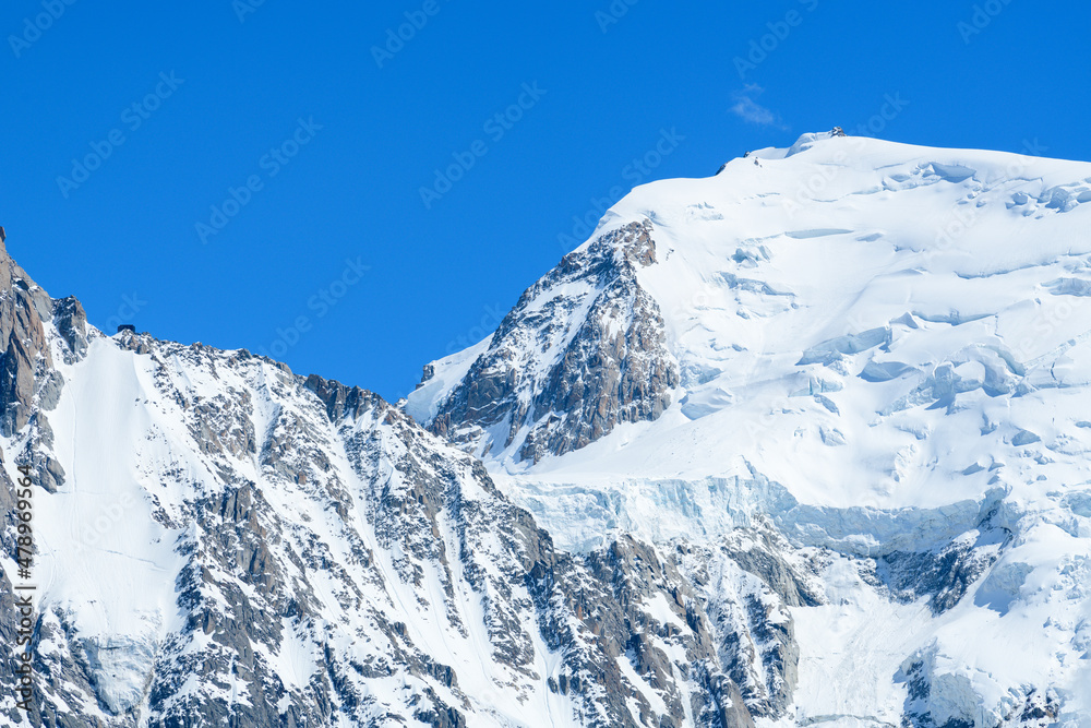 Obraz premium The snowy Col du Midi in the Mont Blanc massif in Europe, France, the Alps, towards Chamonix, in summer, on a sunny day.