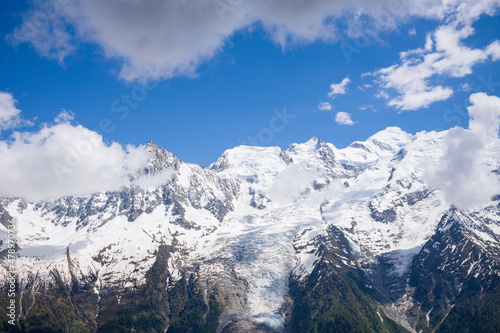 A panoramic view of the Mont Blanc Massif and its snows in the Mont Blanc Massif in Europe, France, the Alps, towards Chamonix, in summer, on a sunny day. © Florent