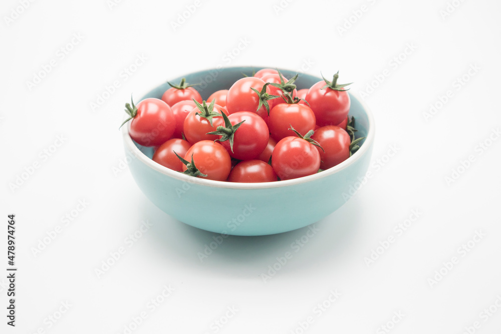 The ceramic bowl is full of tomatoes cherry The ceramic bowl is full of tomatoes cherry
