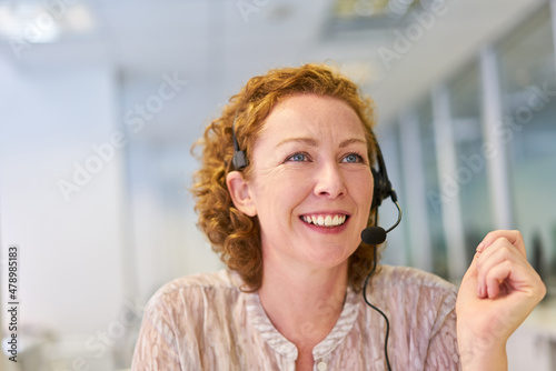 Young woman as operator with headset in the service hotline photo