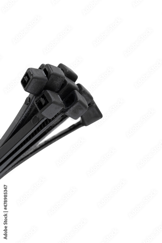 Tie clamps on a white background. Black plastic cable ties clamps close-up. Tie clamps on a white background. Black plastic cable ties clamps close-up.