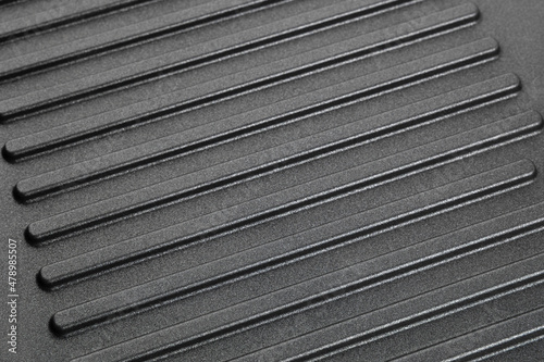 Grill pan surface close up. Ribbed surface of a new frying pan. photo