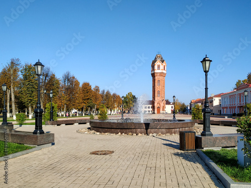 A brick restored water tower in the Art Nouveau architectural style rises on the central square of the ancient city of Staraya Russa, Novgorod region. Industrial architecture of the early XX century.