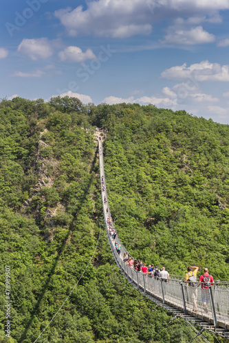 Hikers crossing the Geierlay suspension bridge near Morsdorf, Germany