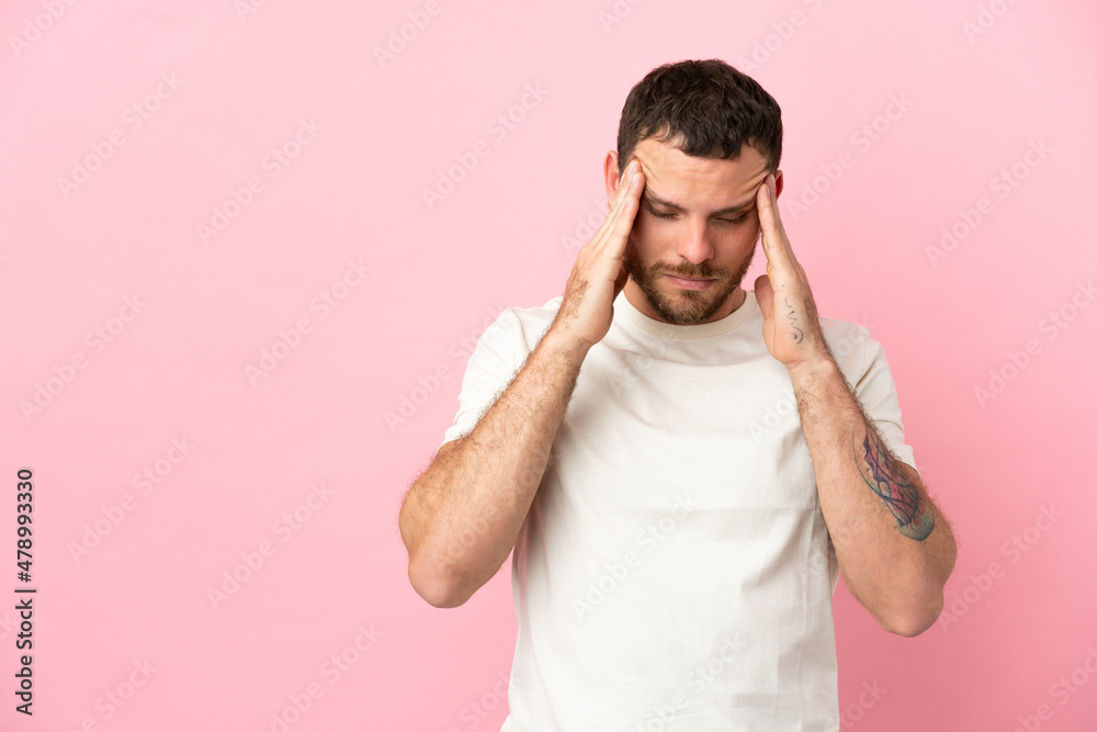 Young Brazilian man isolated on pink background with headache Young Brazilian man isolated on pink background with headache