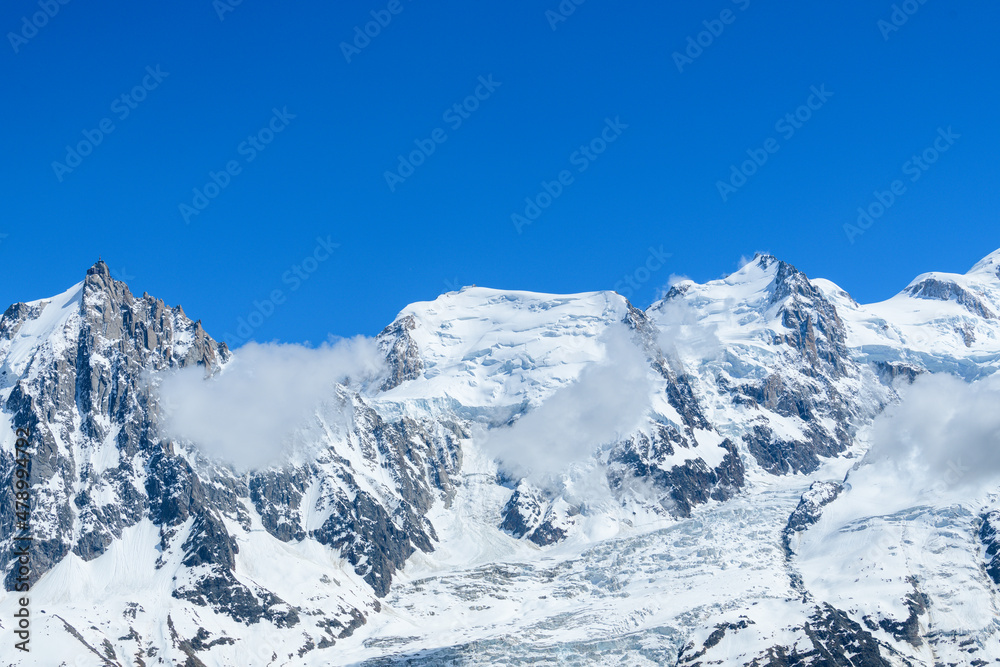 The panoramic view of Mont Blanc du Tacul and Mont Maudit in Europe, France, the Alps, towards Chamonix, in summer, on a sunny day.