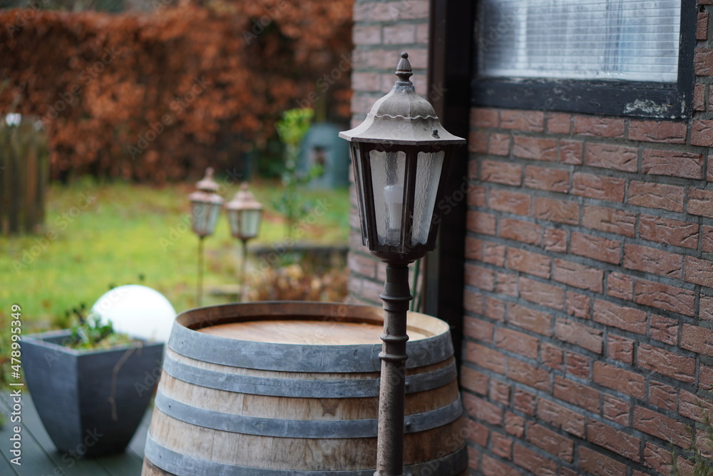 old lantern and wine barrel in the garden