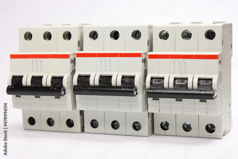 3-pole  current circuit breakers on a white background.