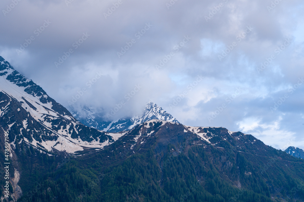 Mont Lachat under the clouds in the Mont Blanc Massif in Europe, France, the Alps, towards Chamonix, in summer. Mont Lachat under the clouds in the Mont Blanc Massif in Europe, France, the Alps, towards Chamonix, in summer.