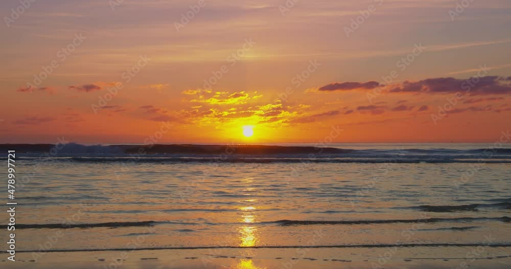 Sunset over the beach on a lightly clouded summer evening Sunset over the beach on a lightly clouded summer evening