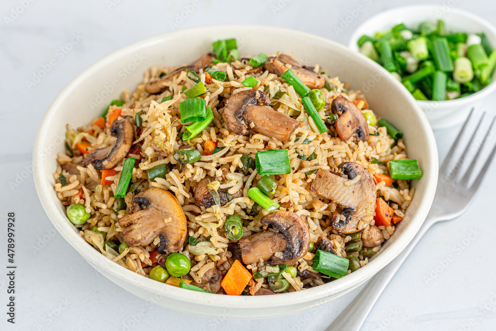 Asian Vegetable and Mushroom Fried Rice in a Bowl on White Background Asian Vegetable and Mushroom Fried Rice in a Bowl on White Background