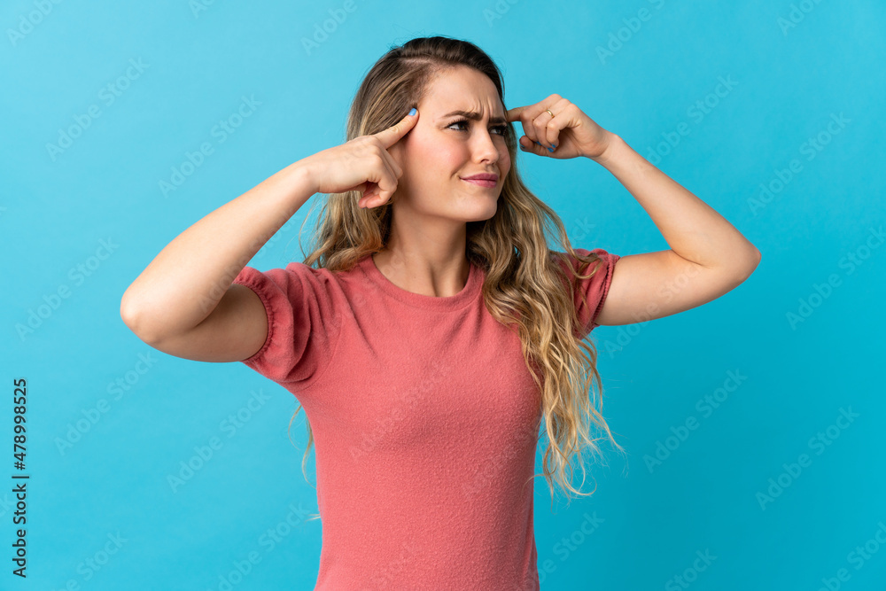 Young Brazilian woman isolated on blue background having doubts and thinking Young Brazilian woman isolated on blue background having doubts and thinking