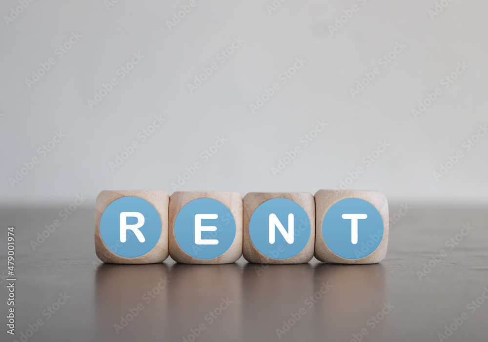RENT- business concept on a white background. Wooden cubes with at place on wooden table RENT- business concept on a white background. Wooden cubes with at place on wooden table