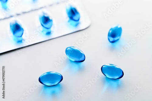 Fotografía Blue Gel Capsules of Ibuprofen on white background