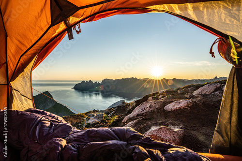 Warm lights of sunrise view from the inside of hiker's tent, Senja island, Troms county, Norway, Scandinavia photo