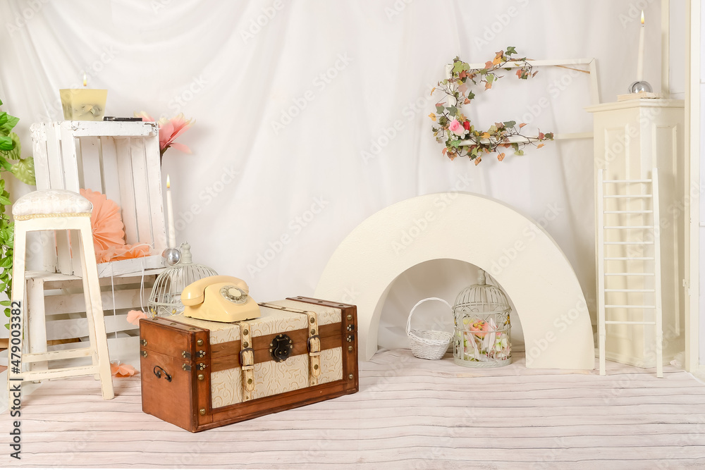 Obraz premium Spring decor romantic with telephone, trunk, candles, flowers and accessories and white cloth in studio.