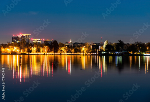 Night view of the colorful reflection of city lights in the lake s water from the Herastrau park. Bucharest  Romania.