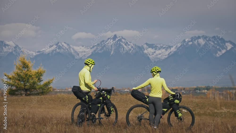 Tourists in tracksuits near riding mixed terrain bicycles Tourists in tracksuits near riding mixed terrain bicycles